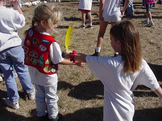 Jessica Nenow handing Kara Boldt a feather.JPG